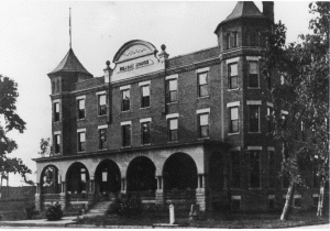The Beach House began its existence as a boarding house on the northeast corner of Ensey and Parke streets. It was then under the conduct of Henry Beach, called “Pap” for short. Some time after his death, the first hotel was burned to the ground, say October, 1869, and rebuilt by Mrs. Beach in 1870. Mrs. Beach proved fully equal to the task of keeping a hotel. The house was second to none outside of large cities; indeed, traveling men preferred the home life comforts here to the more brilliant but not more comfortable caravansaries.